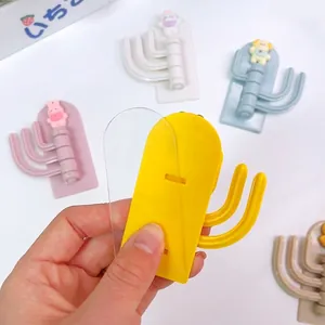Cute cartoon 3-hook adhesive wall hanger showing easy peel-and-stick installation