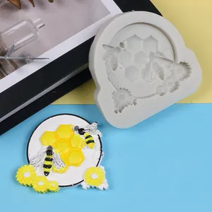 Detailed view of bee and honeycomb silicone mold with finished colorful resin piece