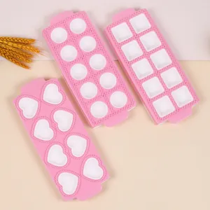 Set of three pink ravioli molds in heart, round, and square shapes for kitchen use.