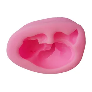 Detailed view of a pink baby-shaped silicone fondant mold for DIY cake decorating