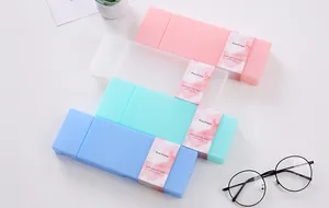 Four macaron-colored PP pencil cases arranged neatly on a white desk with glasses.