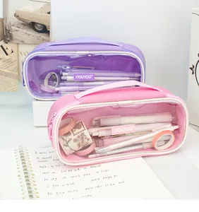 Detail view of purple and pink transparent pencil cases with stationery inside