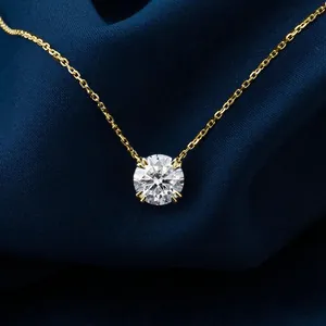 Close-up of a sparkling round-cut moissanite pendant on a 14k gold chain necklace