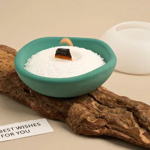 Detail shot of an irregular DIY bowl made from a silicone mold on natural wood
