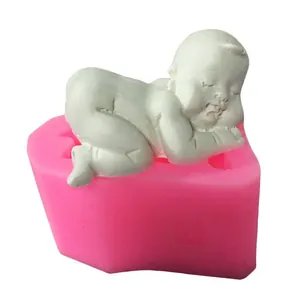 Detailed view of pink silicone baby mold with a white sleeping infant clay model