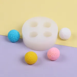 Detailed close-up of a 4-cavity waxberry silicone mold with colorful textured spheres