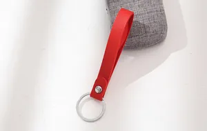 Close-up detail of a bright red leather strap keychain with a silver metal ring.