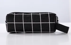 Detailed view of minimalist black and white grid canvas pencil case with zipper closure