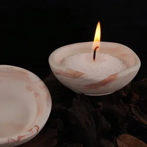 Macro view of irregular marble-patterned bowls used as candle holders and storage