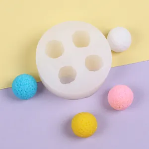 Detailed view of 3D spherical silicone mold with four textured fruit-shaped balls