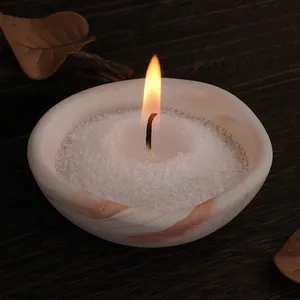 Detailed view of a marble-patterned irregular bowl used as a warm glowing candle holder