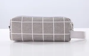 Close-up view of a minimalist gray grid canvas pencil case with a zipper and handle strap.