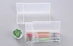 Detailed view of clear PP plastic stationery box showing organized pens and clips inside.