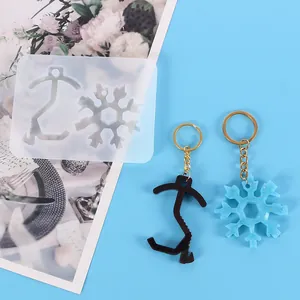 Detail view of DIY silicone mold for snowflake and no-contact elevator pusher keychain tools.