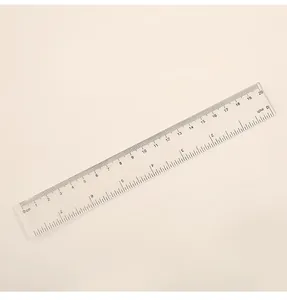 Detailed view of a 20cm transparent plastic ruler with dual metric and imperial scales