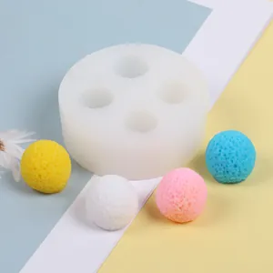 Close-up of a 3D spherical silicone mold with four textured colorful bayberry samples