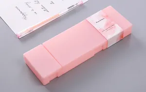 Macro view of a pink frosted plastic pencil box with creative paper packaging band
