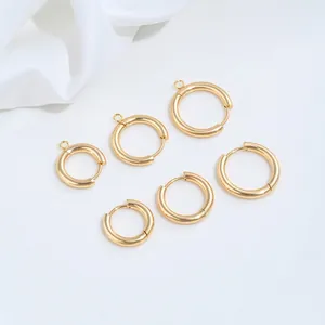 Detailed macro view of golden stainless steel spring buckle hoop earrings for DIY jewelry