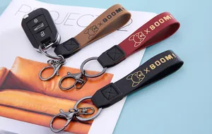 Three stylish leather car keychains in tan, maroon, and black with cute dog motifs