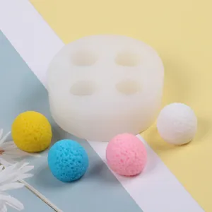 Close-up view of a 4-cavity silicone mold for creating textured berry-shaped ice balls.