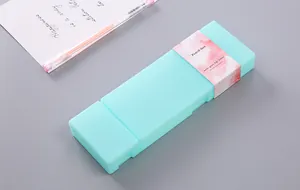 Close-up of a mint green PP pencil box with floral packaging on a desk