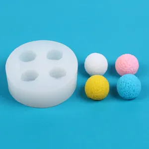 Detailed macro view of 4-cavity spherical silicone mold with textured ball samples