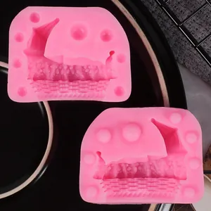 Close-up of pink silicone molds with baby carriage and cradle designs for DIY baking.