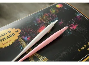 Close-up of pink and white dual-use scratch pens for night view scratch art