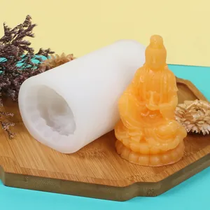 Detailed view of white silicone mold and orange Guanyin Bodhisattva aromatherapy candle