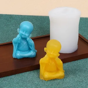 Detailed view of little monk silicone mold with finished wax figures on tray