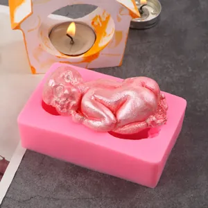 Detailed view of pink silicone mold with a molded sleeping baby fondant figure