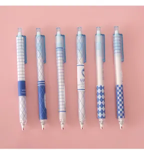 Detailed view of six blue patterned retractable gel pens on pink background