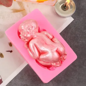 Detailed close-up of a pink baby-shaped liquid silicone mold for DIY fondant cake baking