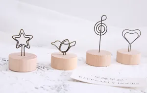 Close-up detail of vintage wooden base message clips with star and bird wire shapes