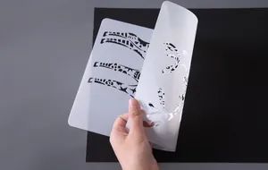 Flexible semi-transparent plastic stencil with intricate giraffe and deer patterns for DIY drawing.