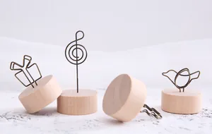 Detailed macro shot of creative Zakka wooden memo clips with bird and musical note iron wire designs