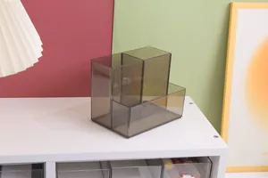 Detail view of a smoke grey three-compartment desktop pen holder and storage box