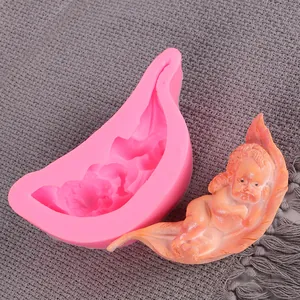 Close-up view of pink liquid silicone DIY baby mold with sleeping baby figurine