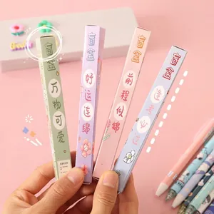 Detail view of four colorful motivational blind box pens in diverse packaging boxes