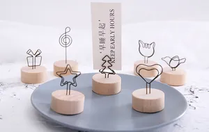 Close-up of various shaped wooden memo holders with star, heart, and tree wire clips.