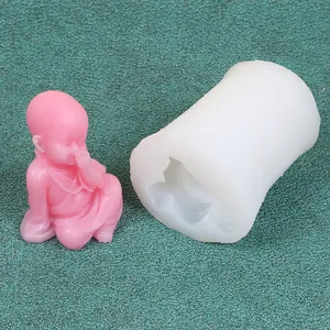 Detailed view of the white silicone mold and a finished pink monk candle ornament