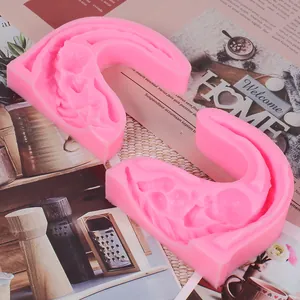 Detailed view of pink silicone baby-shaped mold for DIY fondant cake decorating and baking