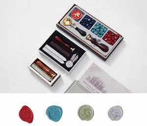 Detail of vintage wax seal kits including stamps, melting spoon, and heart-shaped wax