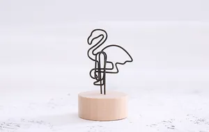 Close-up view of a creative flamingo wire memo clip with a minimalist round wooden base