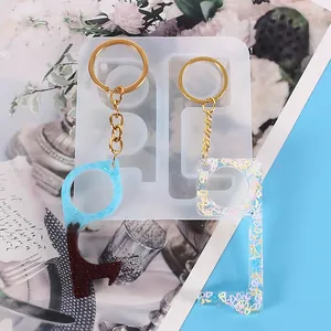 Close-up of DIY no-touch door opener silicone mold with resin keychain craft samples