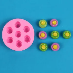 Detailed view of pink silicone mold with finished colorful mini dessert candy models