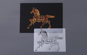 Detail view of horse painting stencil with finished scratch art result on black card.