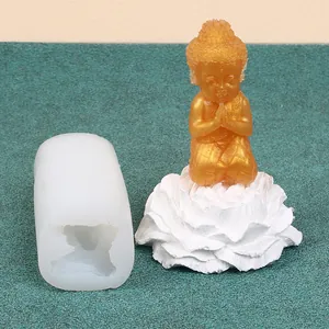 Detail view of little monk silicone mold and finished golden aromatherapy candle figurine