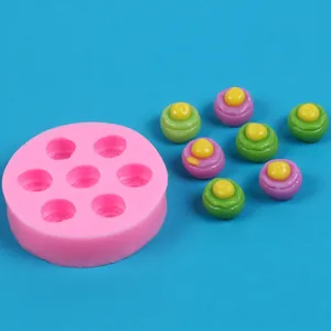 Macro view of a pink 7-cavity silicone mold alongside colorful mini sandwich desserts
