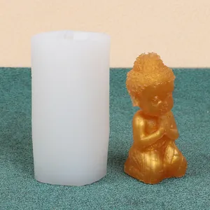 Silicone mold with a finished golden little monk figurine for DIY candle and plaster crafts